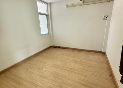 Empty bedroom with hardwood floor and window