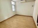 Empty bedroom with hardwood floor and window