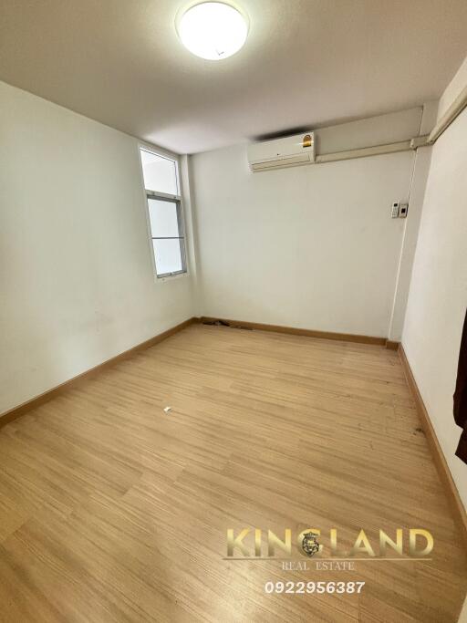 Empty bedroom with hardwood floor and window