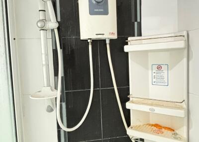 Bathroom with water heater and shower