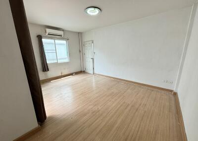 Empty bedroom with wooden floor and window