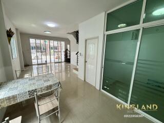 Spacious and well-lit main living area with dining table and glass doors