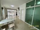 Spacious and well-lit main living area with dining table and glass doors