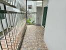 Narrow balcony with tiled floor and metal railing