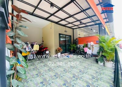 Patio area with tiled flooring and various plants