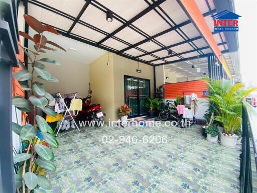 Patio area with tiled flooring and various plants