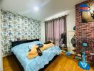 Well-lit bedroom with stylish wall and cozy bedding