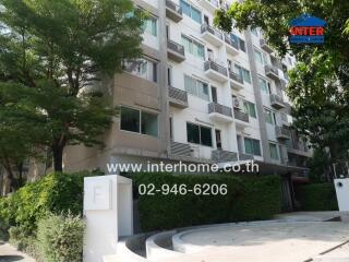 Exterior view of a multi-story residential building with balconies.