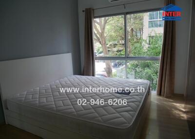 Bedroom with large window and bed