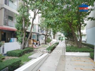 Apartment building exterior with trees and pathways