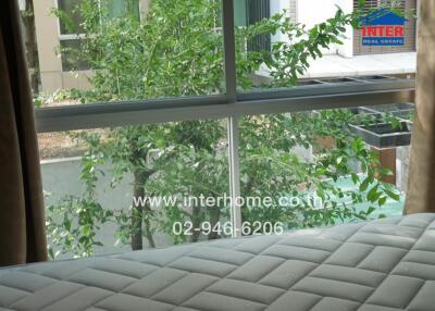 Bedroom with large window and garden view