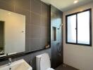 Modern bathroom with shower, toilet, and sink