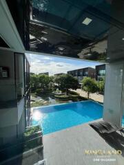 Balcony view with a swimming pool and garden