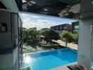 Balcony view with a swimming pool and garden