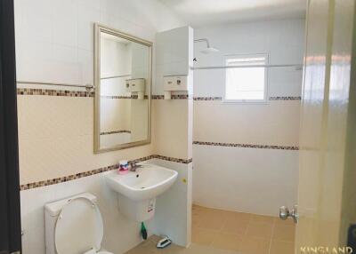 Modern bathroom with sink, toilet, mirror, and shower