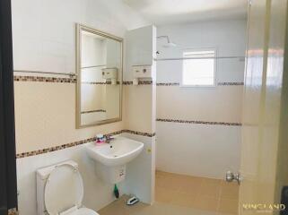 Modern bathroom with sink, toilet, mirror, and shower