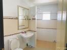 Modern bathroom with sink, toilet, mirror, and shower