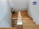 Wooden staircase with wall-mounted handrail