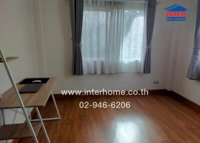 room with wooden floor and window with curtains