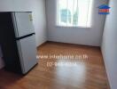 Empty kitchen with refrigerator and window