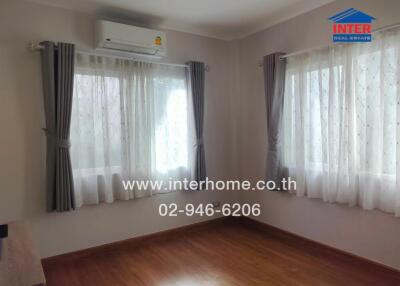 Bedroom with windows, air conditioner, and curtains