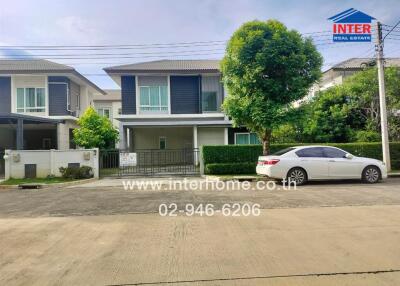 Exterior view of a modern two-story house with a car parked in front