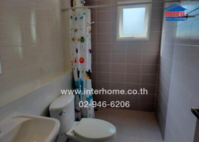 Bathroom with shower curtain and window