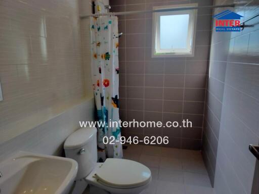 Bathroom with shower curtain and window