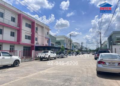 Street view of residential area with multiple three-story buildings