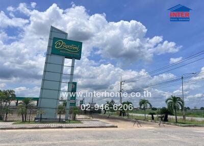 Entrance of a commercial building with a business sign and parking area