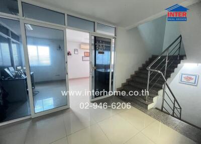 Entrance and stairway in a building with glass door and office room