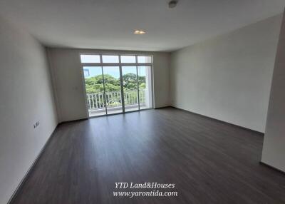 Spacious living room with large windows and balcony access