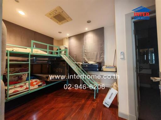 Bedroom with bunk bed and wooden flooring