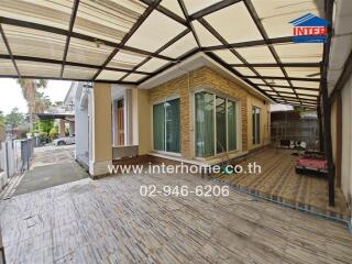 Covered outdoor area with sliding glass doors and stone accent wall