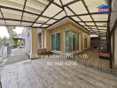 Covered outdoor area with sliding glass doors and stone accent wall