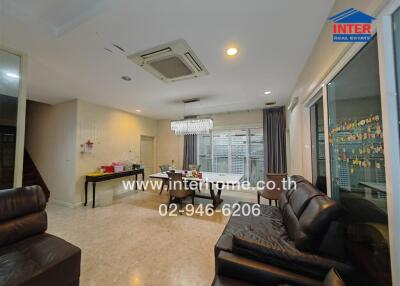 Modern living room with leather furniture and dining area