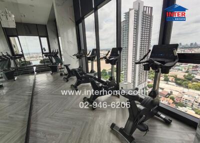 High-rise building gym with exercise bikes and city view