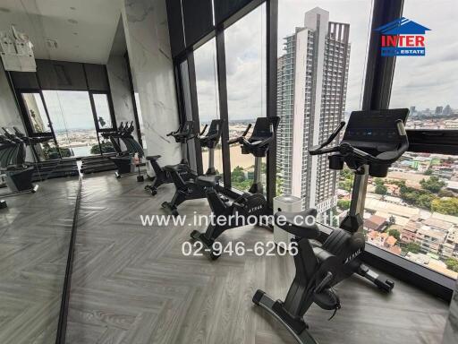 High-rise building gym with exercise bikes and city view