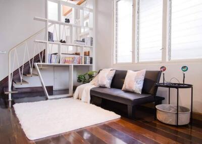 Modern living room with staircase and bookshelf