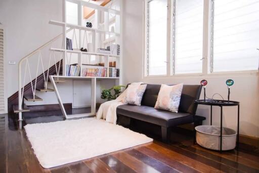 Modern living room with staircase and bookshelf