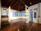 Spacious living room with wooden flooring and stairs