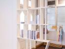 Living area with modern bookshelf and exposed pipes