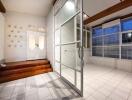 A spacious living area with tiled flooring and glass doors