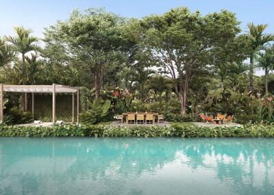 Outdoor seating area by a pool surrounded by lush greenery