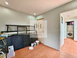 Laundry room with appliances, shelves, and tiled flooring