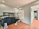 Laundry room with appliances, shelves, and tiled flooring