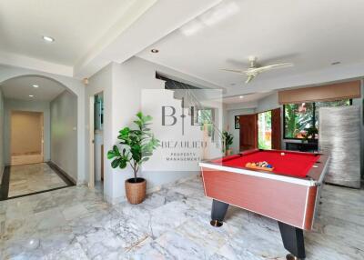 Spacious living area with a pool table