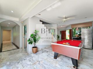 Spacious living area with a pool table