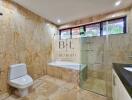 Spacious bathroom with a bathtub, shower, and modern amenities