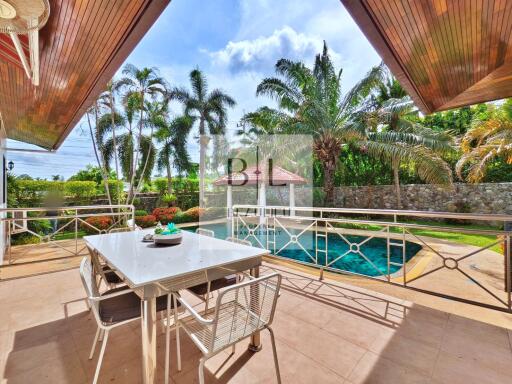 Outdoor patio with dining table and view of pool